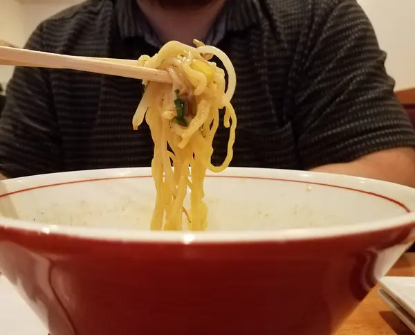 Man Eating Asian Noodles Red Bowl Chopsticks — Stock Photo, Image