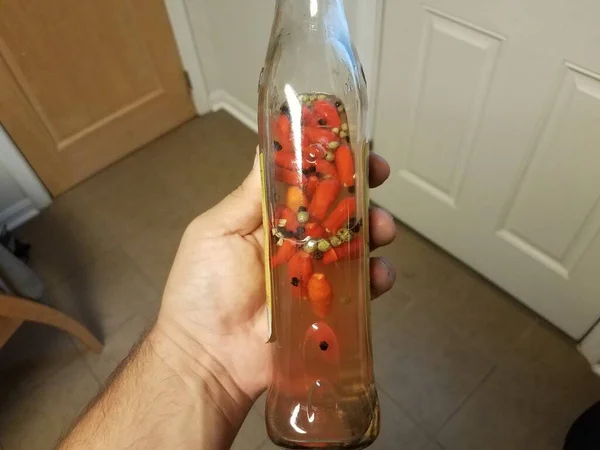 Hand Holding Glass Bottle Homemade Hot Sauce — Stock Photo, Image