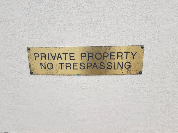 Gold Brass Private Property Trespassing Sign White Wall — Stock Photo, Image