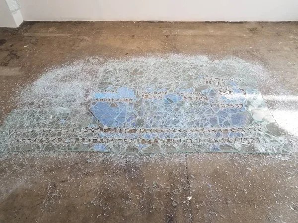 broken window glass shards on cement floor