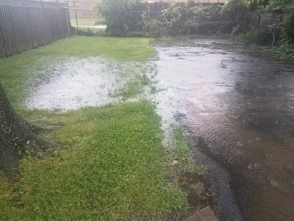 雨中被水淹没的车道和草坪 — 图库照片