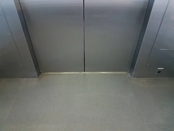 the inside an elevator with shiny metal doors