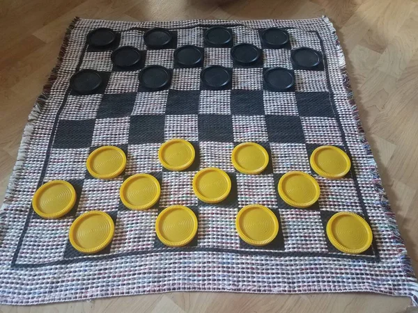 Many Black Yellow Plastic Checkers Fabric Checkerboard — Stock Photo, Image