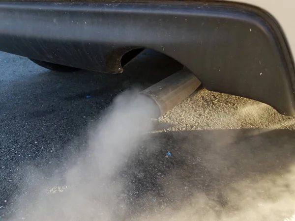 car exhaust or smoke and tailpipe and black asphalt
