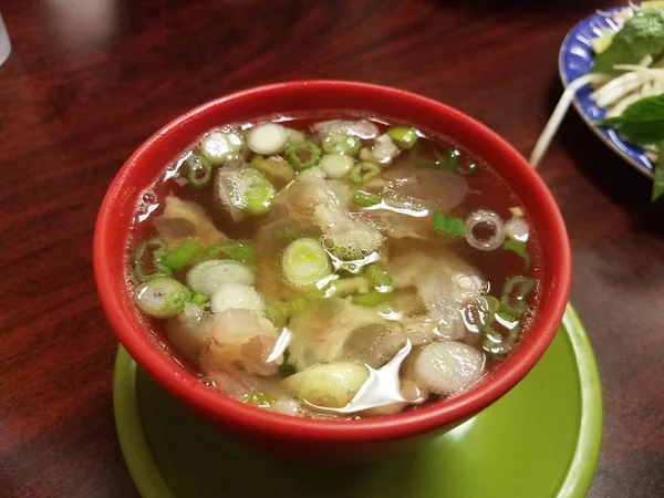 small bowl of hot Vietnamese soup with meat tendon