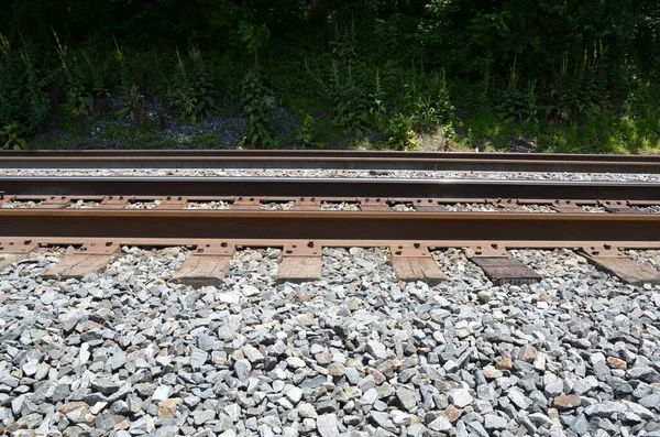 Iron metal railroad train tracks with stones — Stock Photo, Image
