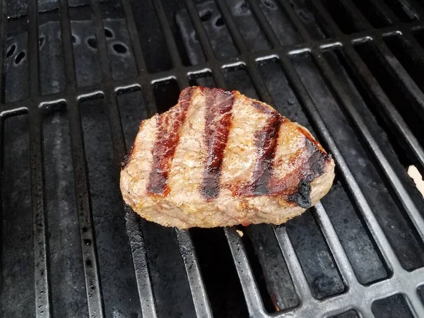 Beef steak cooking on hot barbecue grill — Stock Photo, Image