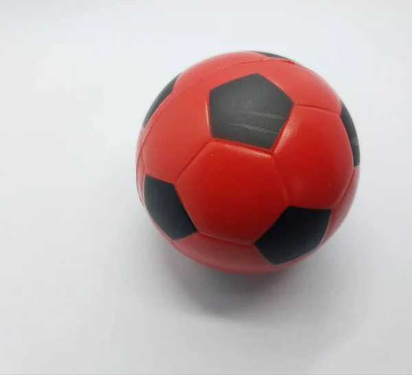 Красный и черный футбольный мяч на белом фоне — стоковое фото