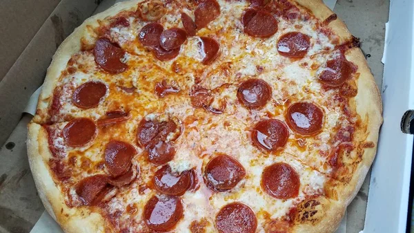 Greasy hot pepperoni and cheese pizza slices — Stock Photo, Image