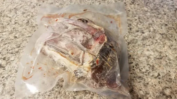 frozen beef meat in plastic bag on counter