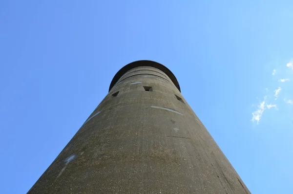 tall cement tower structure with blue sky