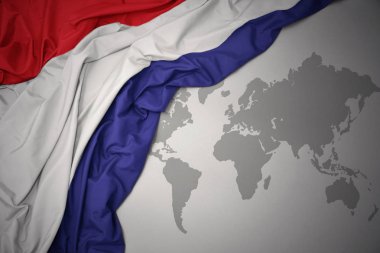 Hollanda gri dünya harita arka plan üzerinde renkli ulusal bayrak sallayarak.