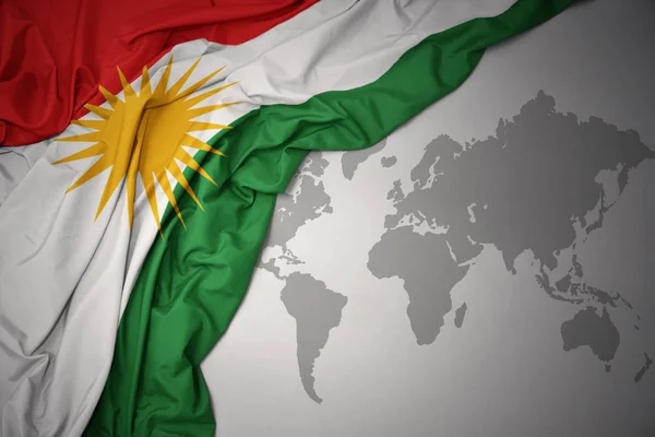 Vifta Med Färgglada Flagga Kurdistan Grå Värld Karta Bakgrund — Stockfoto