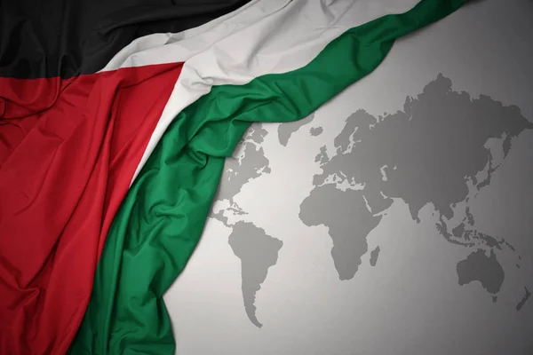 Wuivende Kleurrijke Nationale Vlag Van Palestina Een Grijze Wereld Kaart — Stockfoto