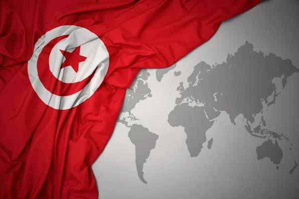 Waving Colorful National Flag Tunisia Gray World Map Background — Stock Photo, Image