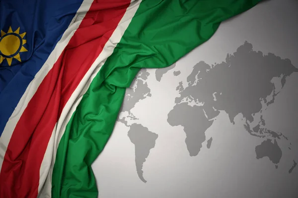 Acenando Bandeira Nacional Colorido Namibia Fundo Mapa Mundo Cinza — Fotografia de Stock