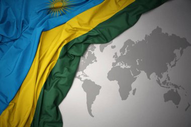 Ruanda gri dünya harita arka plan üzerinde renkli ulusal bayrak sallayarak.