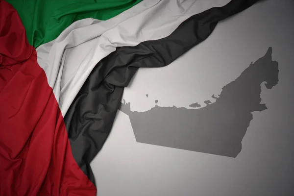 Waving Colorful National Flag United Arab Emirates Gray Map Background — Stock Photo, Image