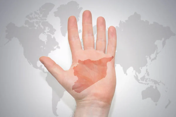 hand with map of syria on the gray world map background. concept