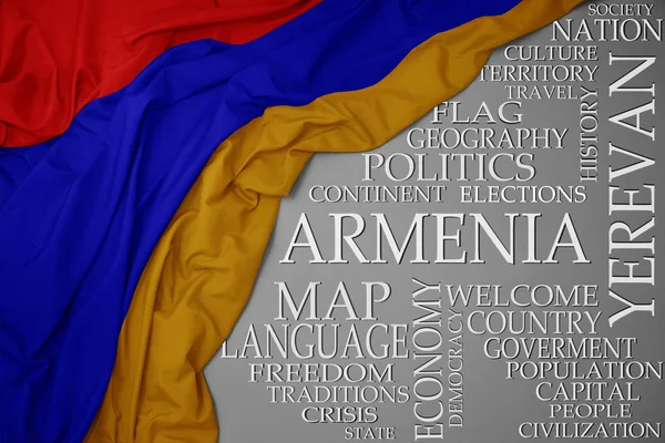 Vifta med färgglada flagga Armenien på en grå bakgrund med viktiga ord om land — Stockfoto
