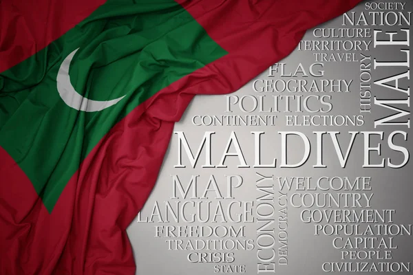 Махаючи барвистим національним прапором мальдів на сірому фоні з важливими словами про країну — стокове фото