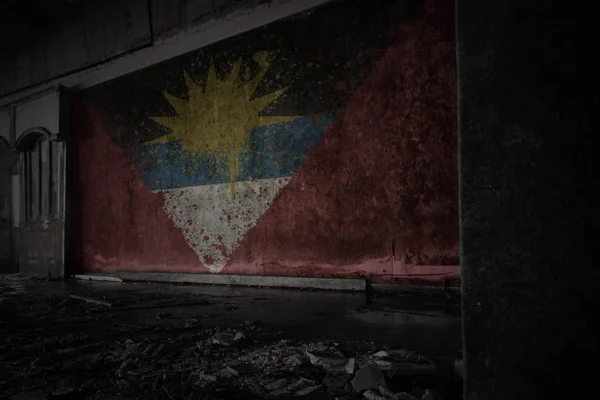 Painted flag of antigua and barbuda on the dirty old wall in an abandoned ruined house. — Stock Photo, Image