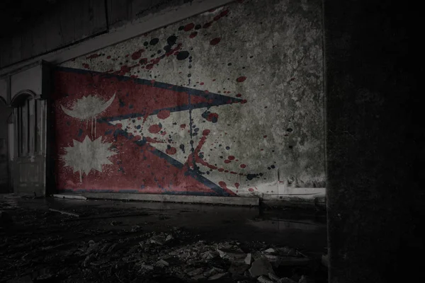 Painted flag of nepal on the dirty old wall in an abandoned ruined house. — Stock Photo, Image