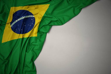 waving national flag of brazil on a gray background. clipart