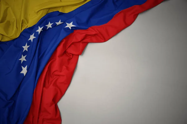 Waving national flag of venezuela on a gray background. — Stock Photo, Image