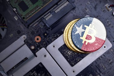 bir bilgisayar elektronik devre kartı üzerinde texas devlet bayrağı ile altın bitcoins. bitcoin madencilik kavramı.
