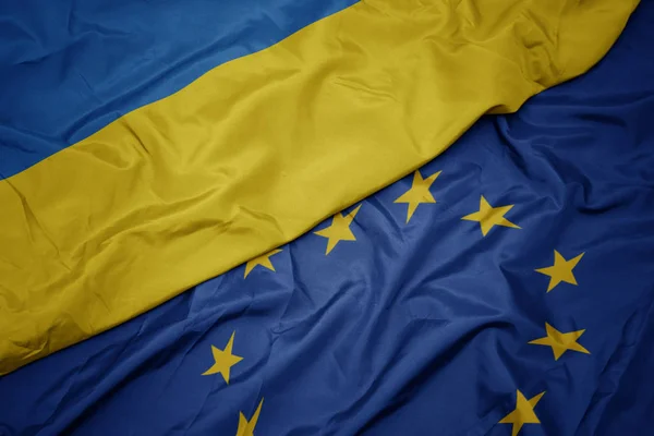 Macha kolorowy flaga Unii Europejskiej i flagi narodowej Ukrainy. — Zdjęcie stockowe