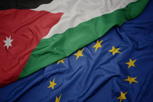 Waving colorful flag of european union and flag of jordan. — Stock Photo, Image