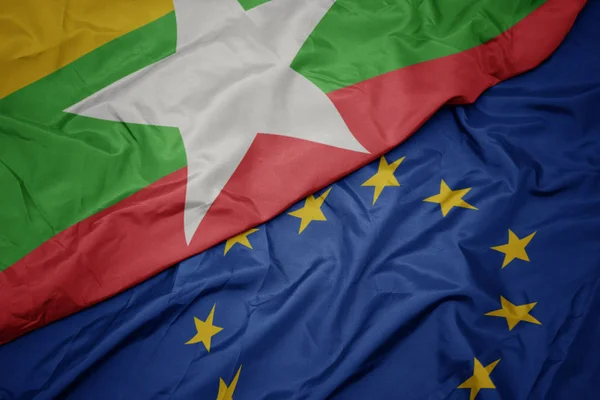 Waving colorful flag of european union and flag of myanmar. — Stock Photo, Image