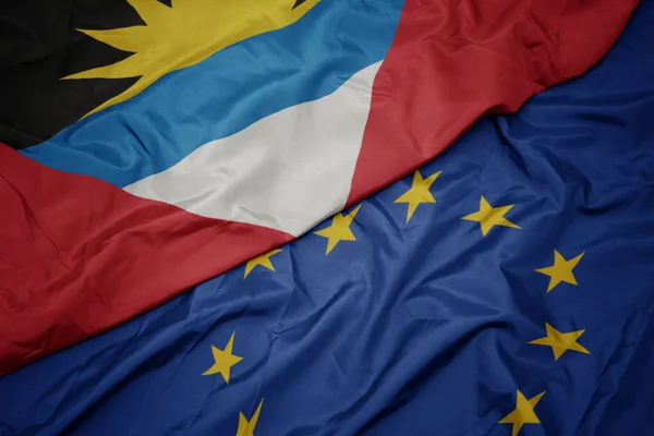 Avrupa Birliği ve antigua ve barbuda bayrağı renkli bayrak sallayarak. — Stok fotoğraf