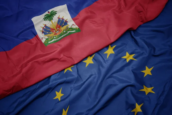 Ondeando colorida bandera de la unión europea y bandera de haiti . —  Fotos de Stock