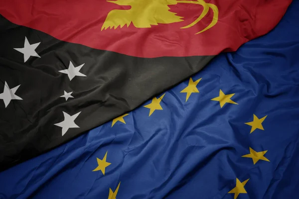 Macha kolorowy flaga Unii Europejskiej i flaga Papui-Nowej Gwinei . — Zdjęcie stockowe