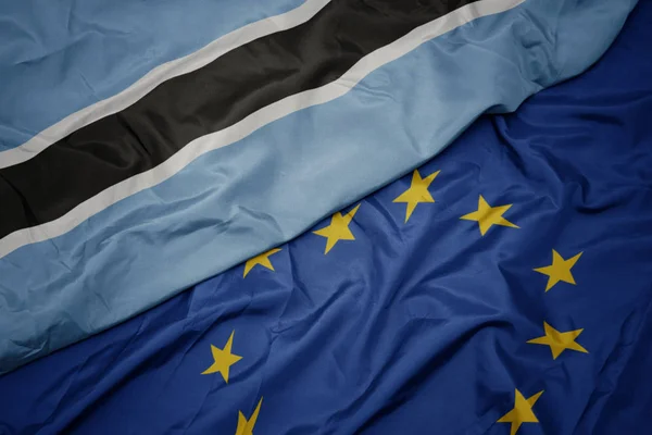 Acenando bandeira colorida da união europeia e bandeira do Botsuana . — Fotografia de Stock