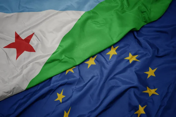 Agitant drapeau coloré de l'union européenne et drapeau de djibouti . — Photo