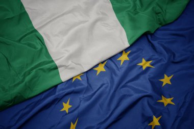 avrupa birliği ve nijerya bayrağı renkli bayrak sallayarak.