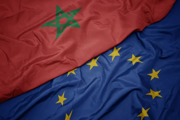 Waving colorful flag of european union and flag of morocco. — Stock Photo, Image