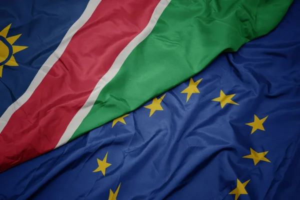 Waving colorful flag of european union and flag of namibia. — Stock Photo, Image