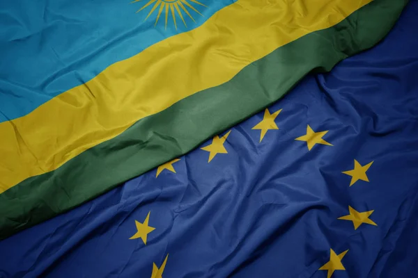 Az Európai Unió színes zászlója és Ruanda zászlaja. — Stock Fotó