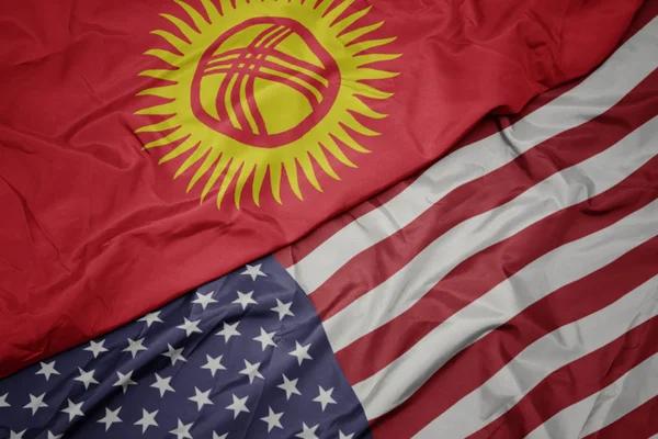 Waving colorful flag of united states of america and national flag of kyrgyzstan. — Stock Photo, Image