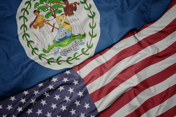 Ondeando colorida bandera de Estados Unidos de América y bandera nacional de Belice . — Foto de Stock