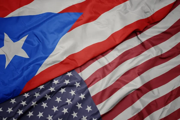 Waving colorful flag of united states of america and national flag of puerto rico. — Stock Photo, Image