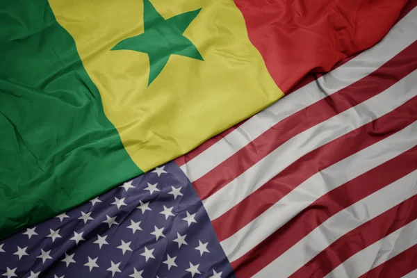 Waving colorful flag of united states of america and national flag of senegal. — Stock Photo, Image