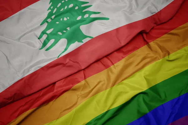 Waving colorful gay rainbow flag and national flag of lebanon. — Stock Photo, Image