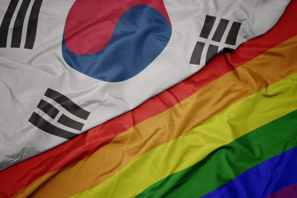 Waving colorful gay rainbow flag and national flag of south korea. — Stock Photo, Image