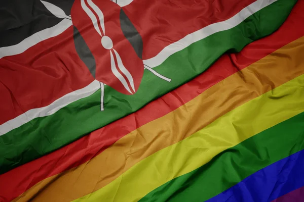 Waving colorful gay rainbow flag and national flag of kenya. — Stock Photo, Image