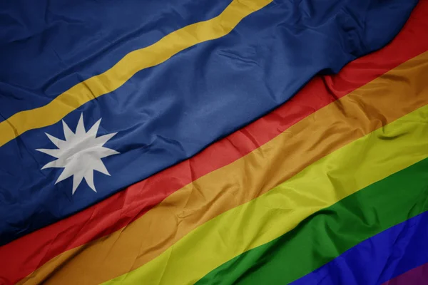 Waving colorful gay rainbow flag and national flag of Nauru. — Stock Photo, Image